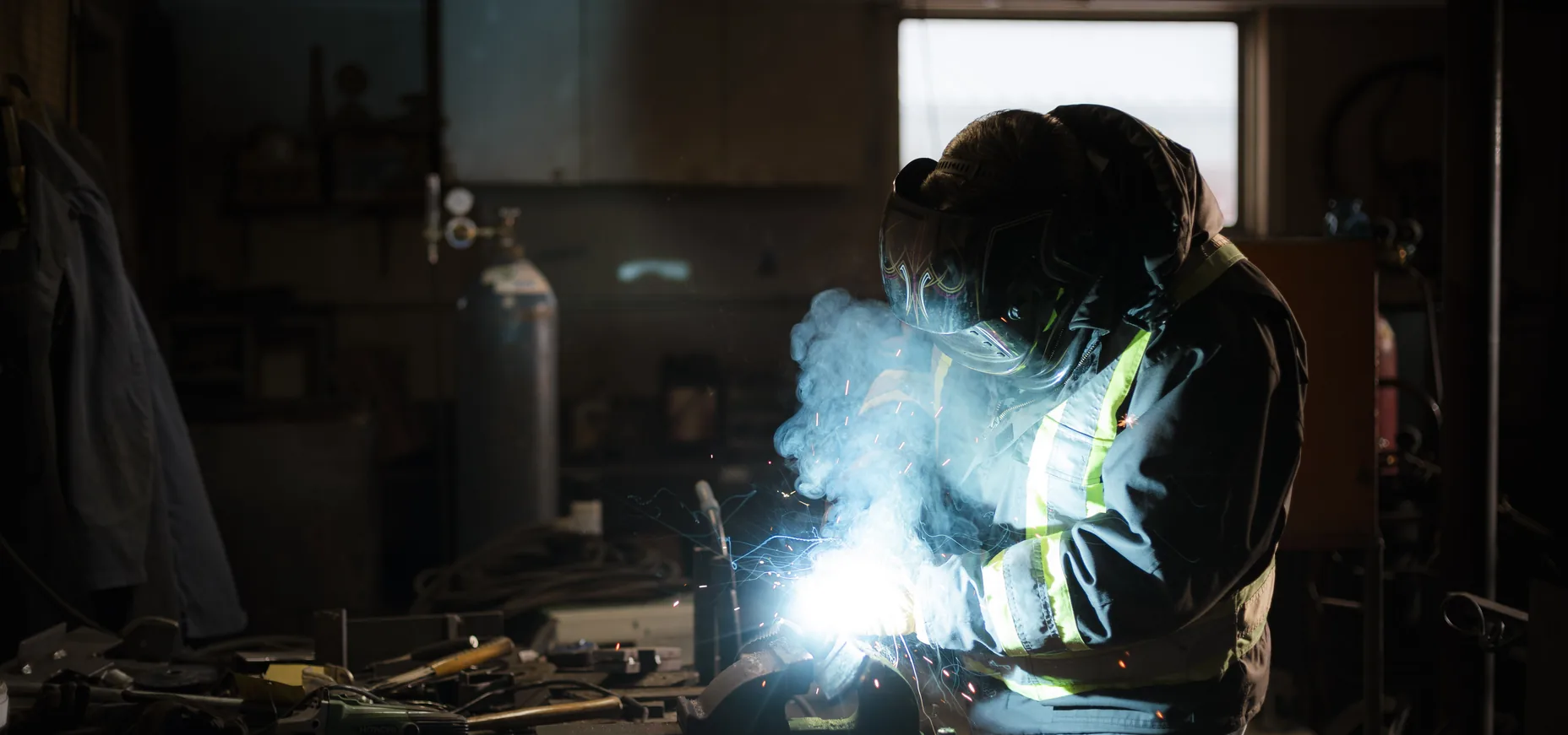 A welder under the arc at the bench in the GEN shop in Coaldale, Alberta