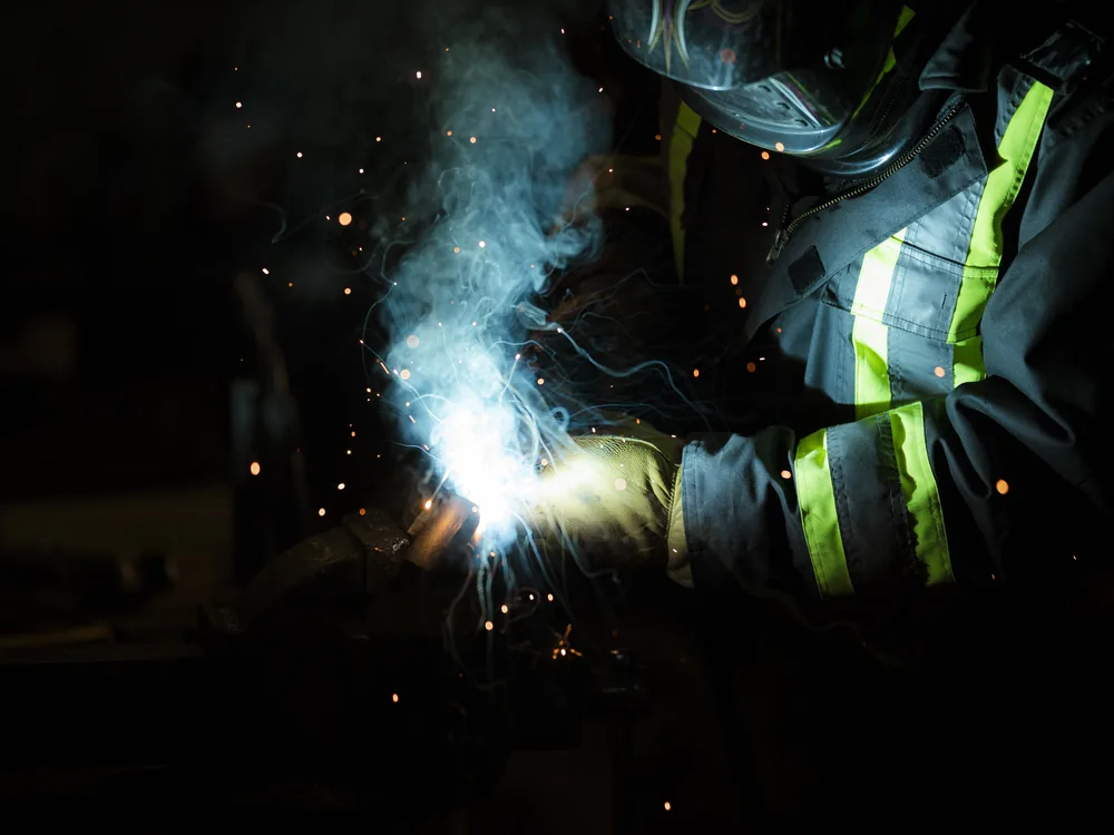 A welder laying down a bead under the arc
